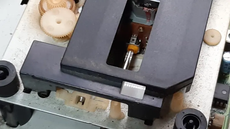 セガサターン本体内部の黄色いネジにプラスドライバーを差し込んだ様子